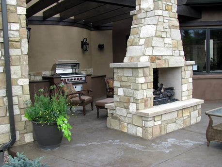 backyard landscaping patio with stone fireplace